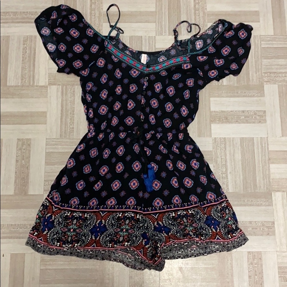 A black romper w a pink, blue, and orange romper.